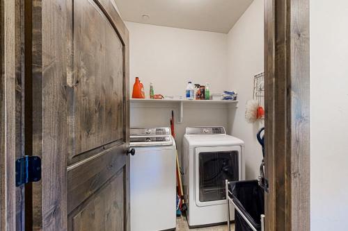 a small kitchen with a stove and a washer and dryer at Black Rock Ridge - Unit L in Heber City