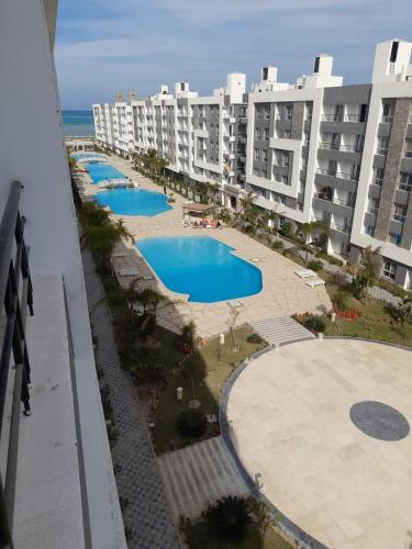 an aerial view of an apartment complex with several pools at Chalet for rent in fanadir bay , Hurghada in Hurghada