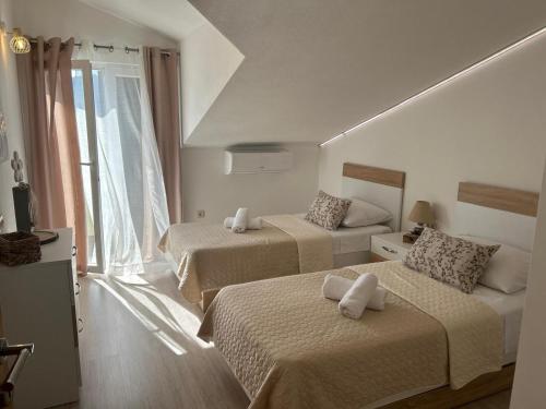 Postel nebo postele na pokoji v ubytování Apartmani Palada