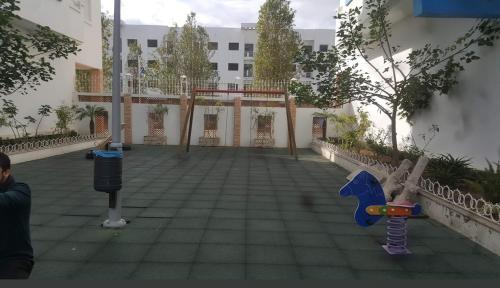 a courtyard with a playground in a building at martil in Martil