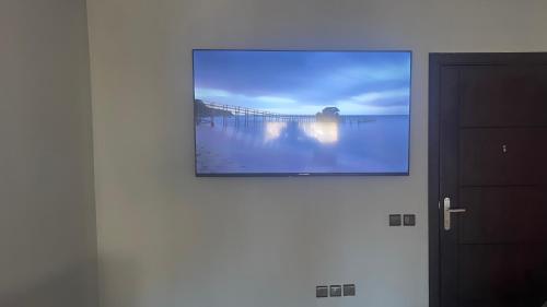 a painting on a wall with a picture of a pier at martil in Martil
