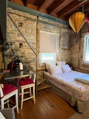 a bedroom with a bed in a stone wall at Mastixi in Chios