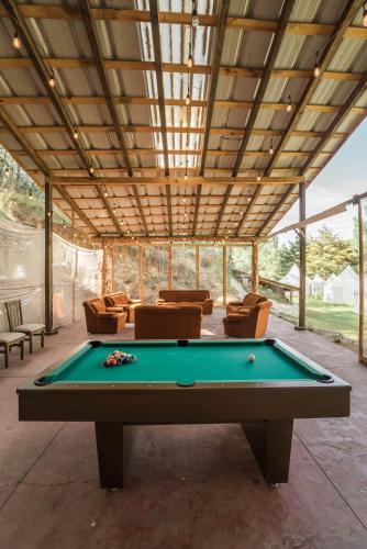 a pool table in the middle of a living room at Exclusivo glamping en el bosque in Ferrería de Tula