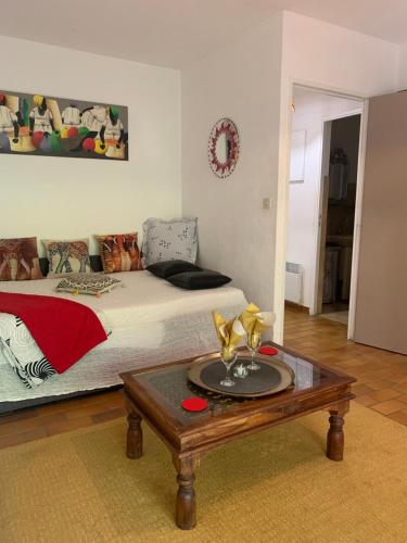 - une chambre avec un lit et une table basse dans l'établissement Studio AZUR, à Six-Fours-les-Plages