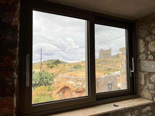 a window with a view of a castle at Kassis Mansion in Páliros