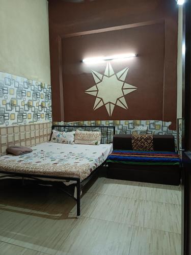 a room with two beds and a star on the wall at SIDHU GUEST HOUES -400 walking distance From golden Temple in Amritsar