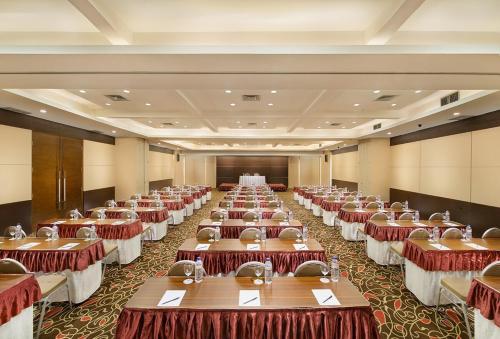 a row of tables in a large room at Grand Cakra Hotel Malang in Malang