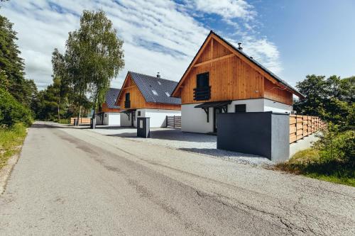 a house on the side of a dirt road at Chaty ForRest in Valča