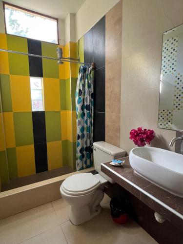 a bathroom with a toilet and a sink at Stone House Mancora in Máncora