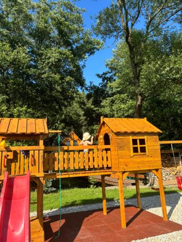 a wooden playground with a bird house on it at Chaty ForRest in Valča