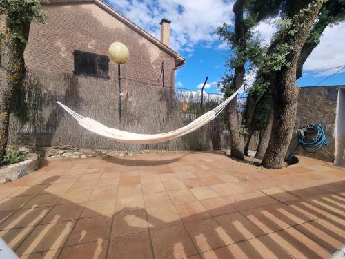 a hammock hanging from a fence in a yard at VUT EL Mogollón in Guadalajara
