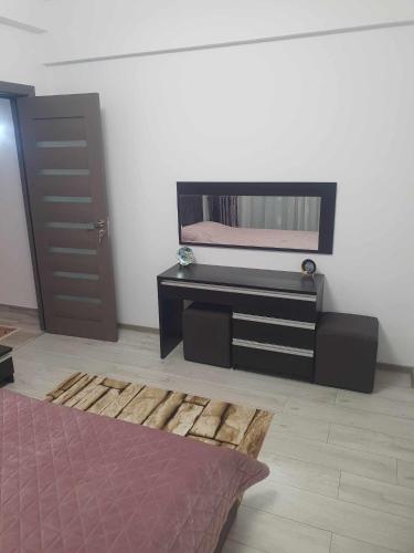 a room with a tv and a rug and a door at SYS Apartament in Constanţa