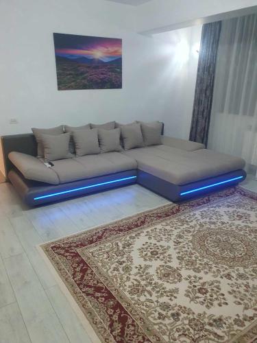 a couch in a living room with a blue light at SYS Apartament in Constanţa