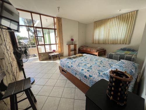 a bedroom with a bed and a television in a room at Stone House Mancora in Máncora