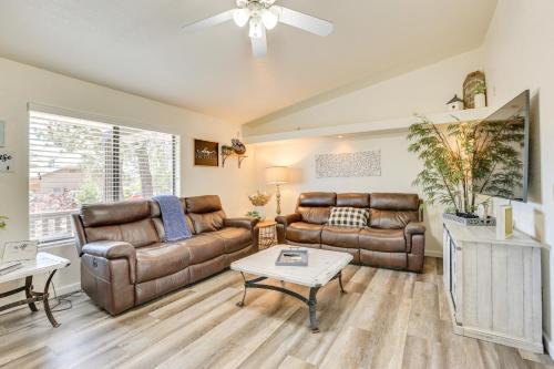 a living room with a couch and a table at Hike and Golf Family Home with Deck in Payson! in Payson