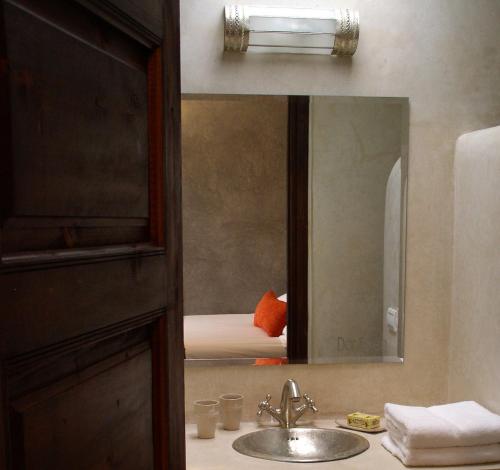 a bathroom with a sink and a mirror at Riad Dar Selen in Marrakech