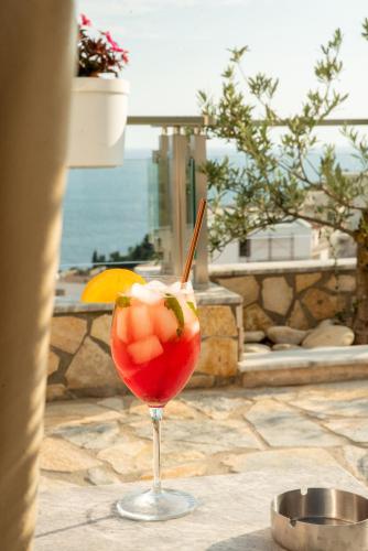 a drink in a glass sitting on a table at Hotel Freiburg in Ulcinj