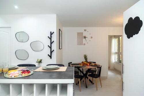 a kitchen and dining room with a table and chairs at Appartement Paris Creteil Le Lac in Créteil