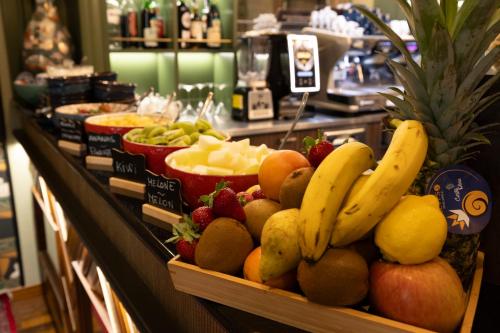 a display of fruit on a counter in a store at Hotel Indigo Turin by IHG in Turin