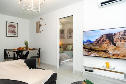 a living room with a flat screen tv on a wall at Appartement Paris Creteil Le Lac in Créteil