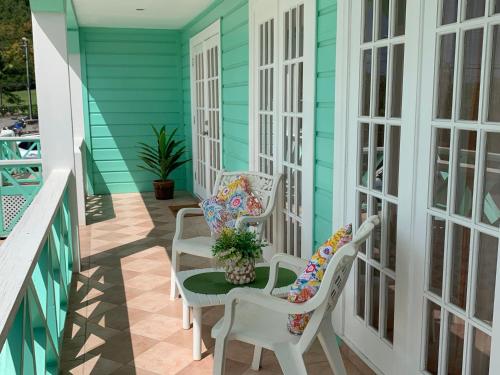 a porch with two chairs and a table at Jolly Holiday Apartment 1 B in Saint Mary