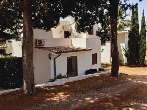 a white house with trees in front of it at Relais LaValle in Taranto
