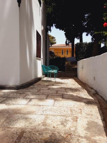 a green chair sitting next to a building at Relais LaValle in Taranto