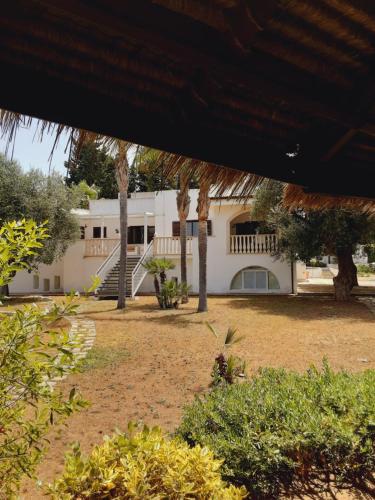 a white house with trees in front of it at Relais LaValle in Taranto