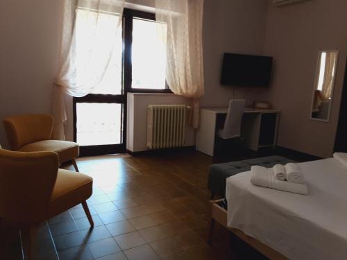 a hotel room with a bed and a chair at Relais LaValle in Taranto