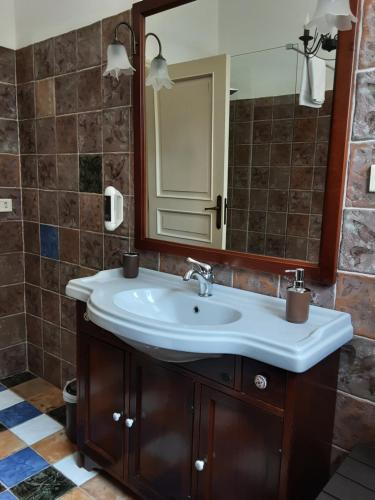 a bathroom with a sink and a mirror at Relais LaValle in Taranto