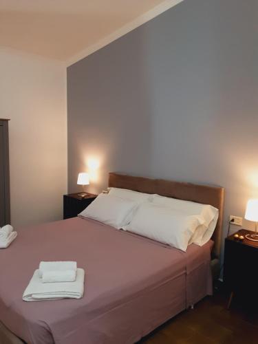 a bedroom with a bed with two towels on it at Relais LaValle in Taranto