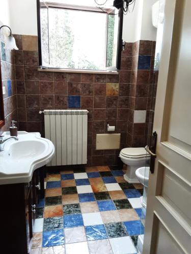 a bathroom with a sink and a toilet at Relais LaValle in Taranto