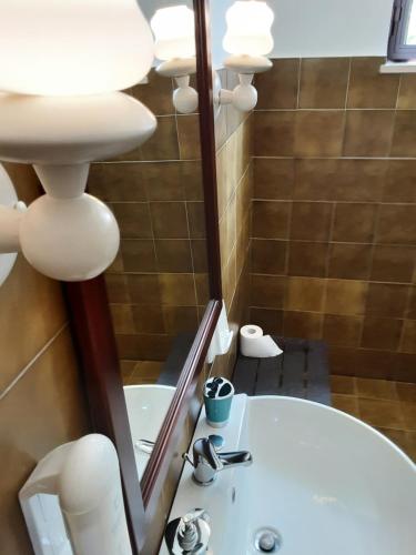 a bathroom with a white sink and a mirror at Relais LaValle in Taranto
