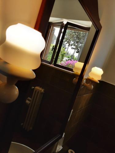 a bathroom with a mirror and a window at Relais LaValle in Taranto