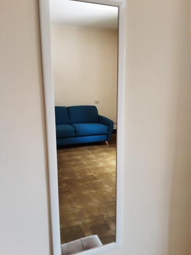 a blue couch in a living room through a mirror at Relais LaValle in Taranto
