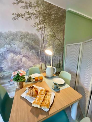 a wooden table with a plate of food on it at Happy Family Apartments Maggiolino in Genova
