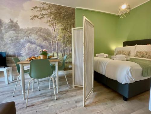 a bedroom with a bed and a table and chairs at Happy Family Apartments Maggiolino in Genova