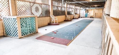 an empty room with a ping pong table and chairs at Luxury Ocean Front By Barefoot Landing in Myrtle Beach