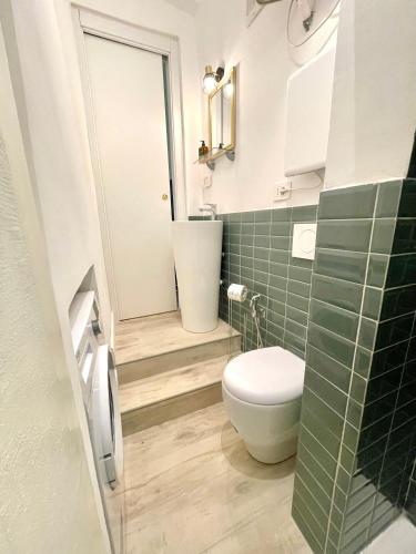 a bathroom with a toilet and a sink at Happy Family Apartments Maggiolino in Genova
