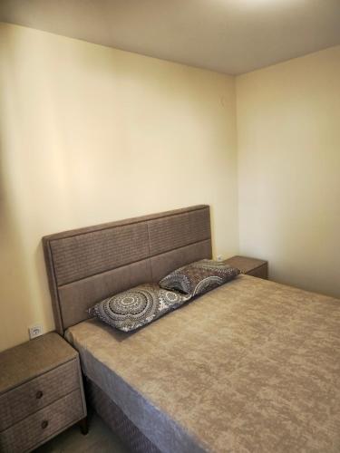 a bedroom with a bed with a pillow on it at Luka Apartments in Bečići