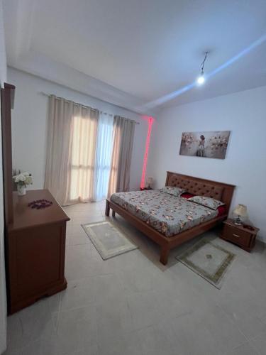 a bedroom with a bed and a table in it at Appartement slim centre sousse in Sousse