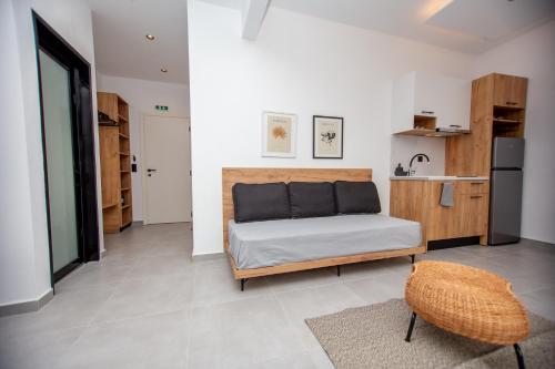 a bedroom with a bed and a small kitchen at LA PLAZA luxury suites NEA VRASNA in Nea Vrasna