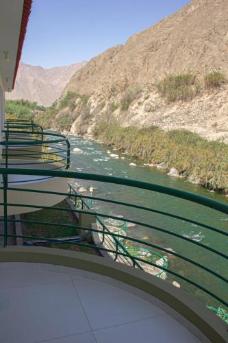 a balcony with benches overlooking a river in a canyon at Villasol Hotel in Lunahuaná