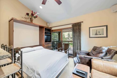 a bedroom with a bed and a living room at Lodge at Lionshead 310 in Vail