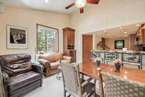 a kitchen and living room with a table and chairs at Lodge at Lionshead 310 in Vail