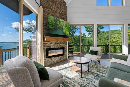 a living room with a fireplace and a balcony at Jolene Lookout in Dandridge
