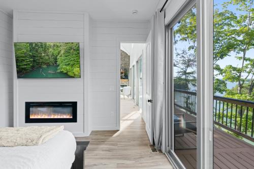 a bedroom with a fireplace and a tv on a wall at Jolene Lookout in Dandridge