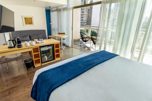 a hotel room with a bed and a television at Hotel Nacional Inn Jaragua Sao Paulo in Sao Paulo