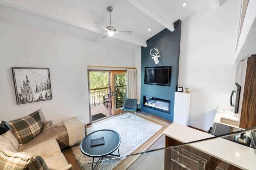 a living room with a couch and a table at Lodge at Lionshead 320 in Vail