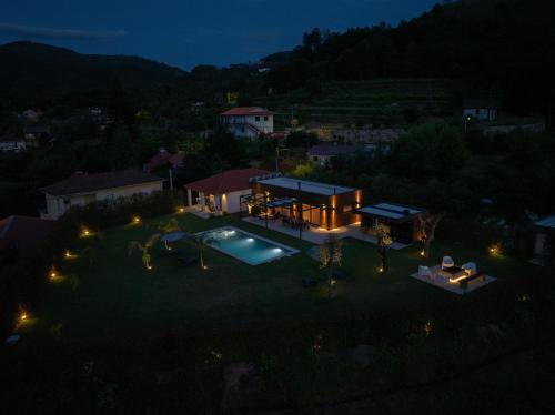 an aerial view of a house with a swimming pool at night at Refúgio das Oliveiras, Mondim de Bastos in Mondim de Basto